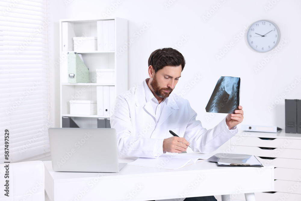 Doctor writing results from MRI scan in hospital Doctor writing results from MRI scan in hospital