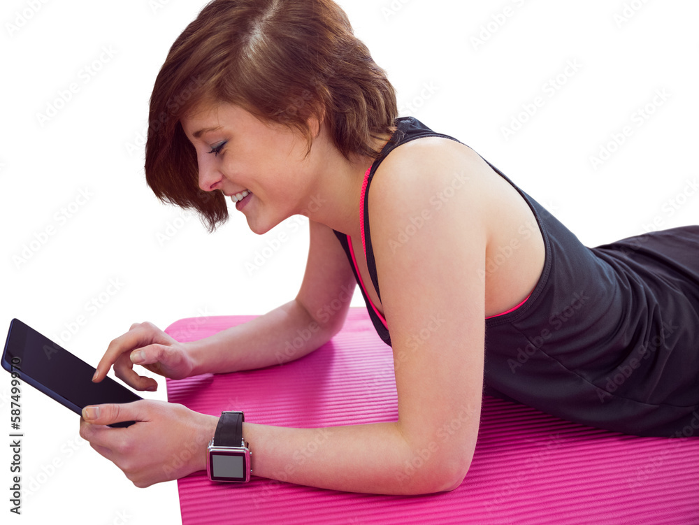 Fit woman using digital tablet on exercise mat Fit woman using digital tablet on exercise mat