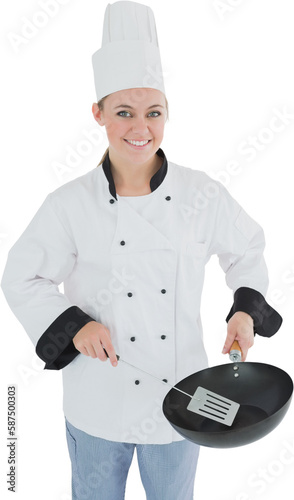 Portrait of chef using spetula and frying pan