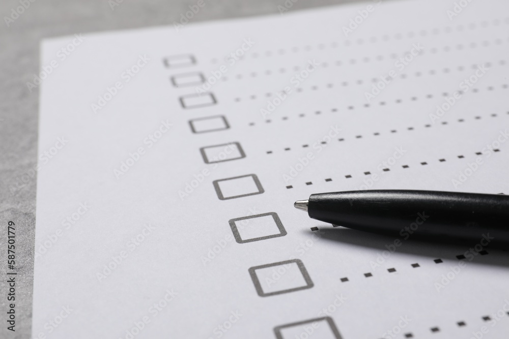 Paper sheet with checkboxes and pen on light grey table, closeup. Checklist Paper sheet with checkboxes and pen on light grey table, closeup. Checklist