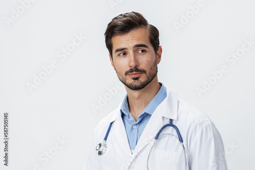 Man doctor in white coat with stethoscope and eyeglasses on white isolated background looking into camera, copy space, space for text, health