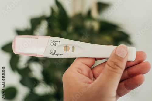 Close up woman holding pregnancy test