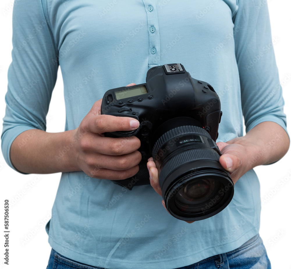 Mid section of female photographer holding digital camera Mid section of female photographer holding digital camera