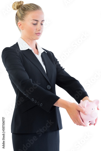 Businesswoman holding piggy bank