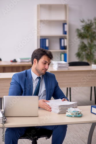 Young male employee working in the office