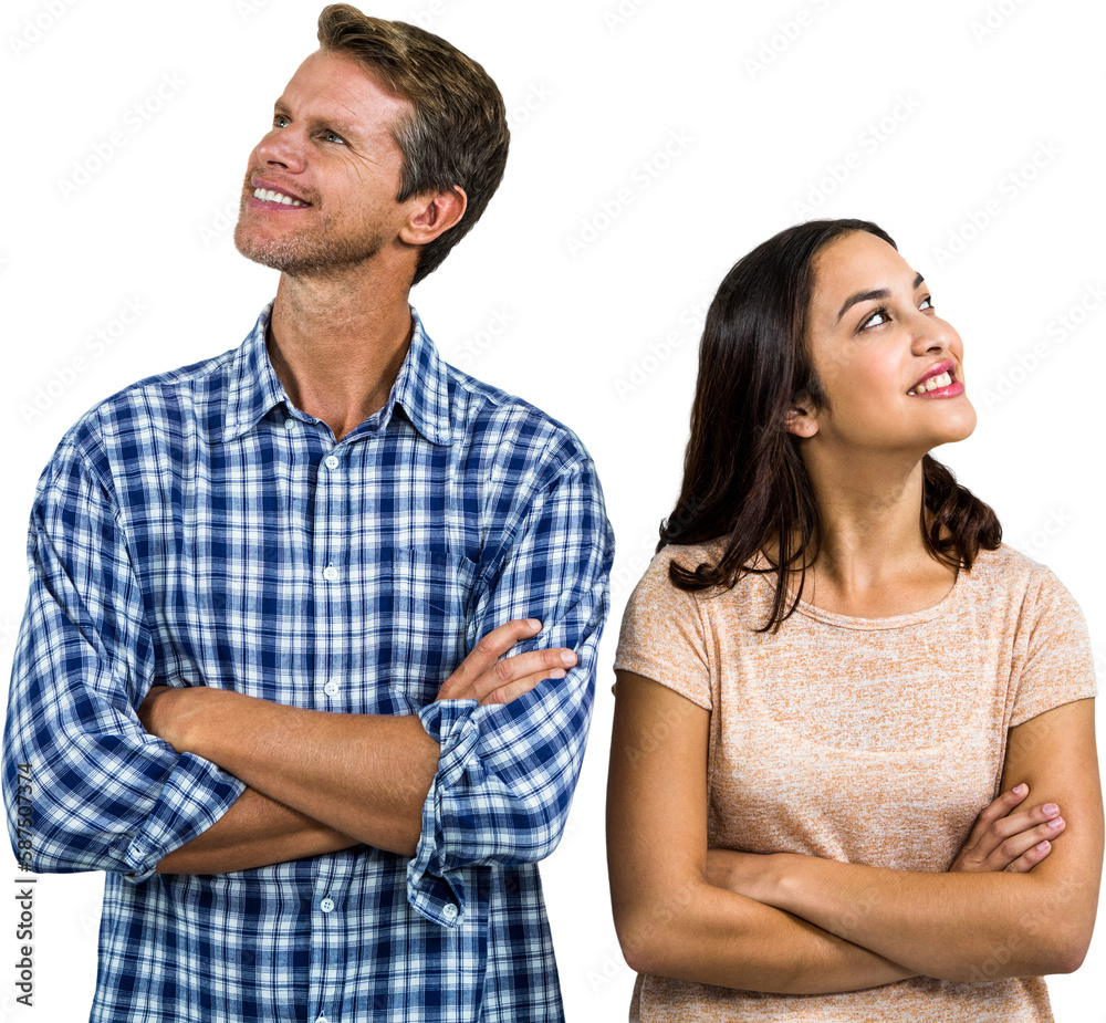 Smiling couple standing with arms crossed Smiling couple standing with arms crossed