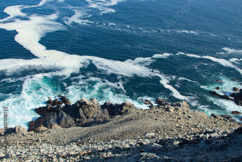 sea waves crash against the rocks photo