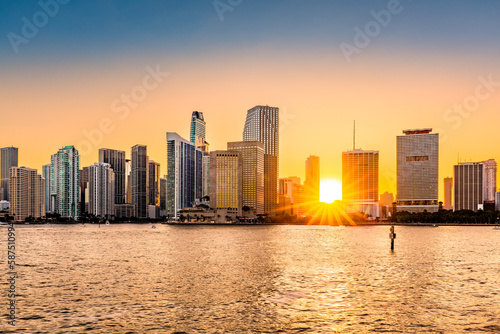 Miami  Florida skyline with sunbeams shining through the skyscrapers. Miami is a majority-minority city and a major center and leader in finance  commerce  culture  arts  and international trade.