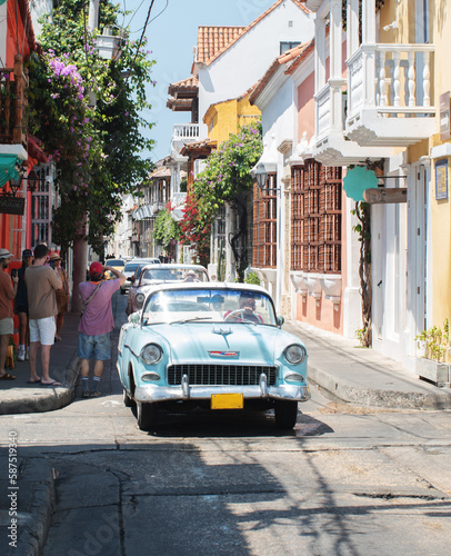 classic blue car touring the streets of the walled city in cartagena de indias