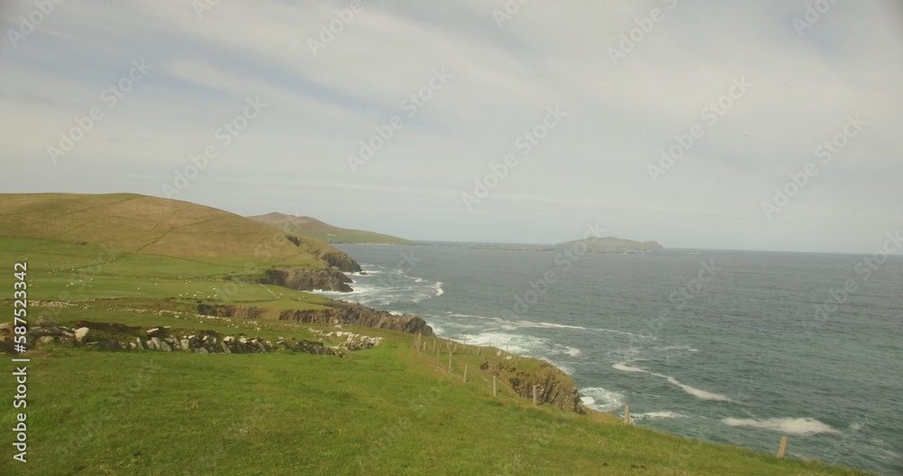 Scenic view of landscape by ocean Scenic view of landscape by ocean