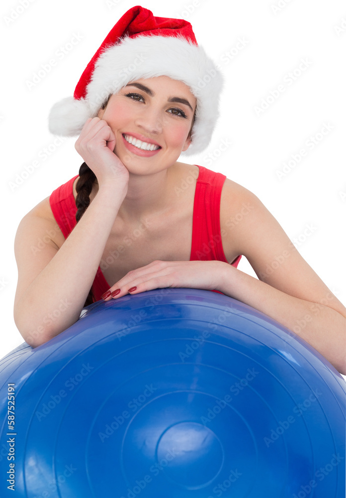 Festive fit brunette leaning on exercise ball Festive fit brunette leaning on exercise ball