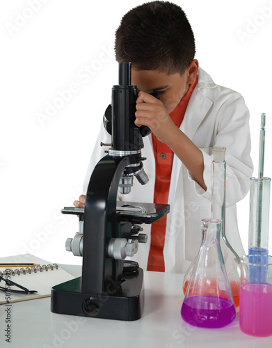 Schoolboy examing through microscope photo
