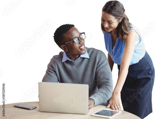 Smiling business people discussing over laptop
