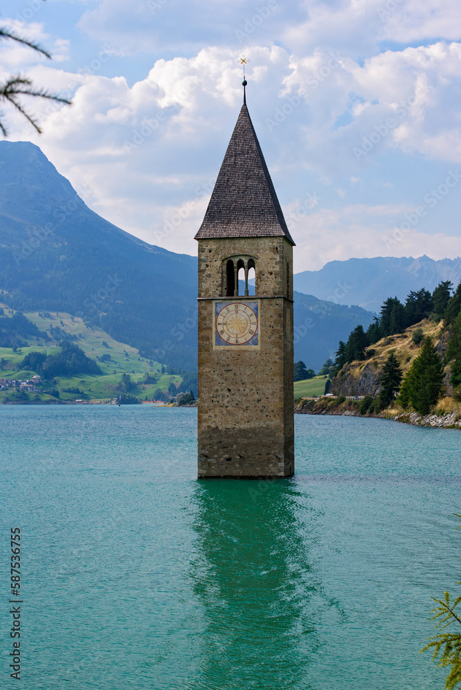 Medieval church bell tower rising from Lake Resia. Italy
