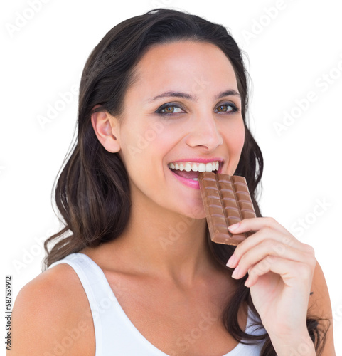 Pretty brunette eating bar of chocolate