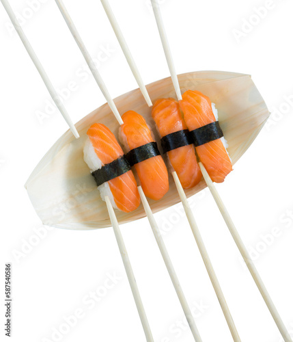 Close up of salmon sushi with chopsticks in plate