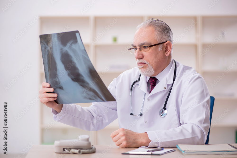 Old male doctor radiologist working in the clinic Old male doctor radiologist working in the clinic