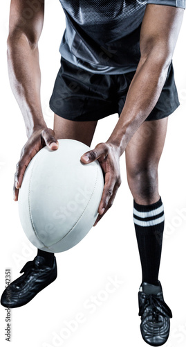 Low section of athlete holding rugby ball