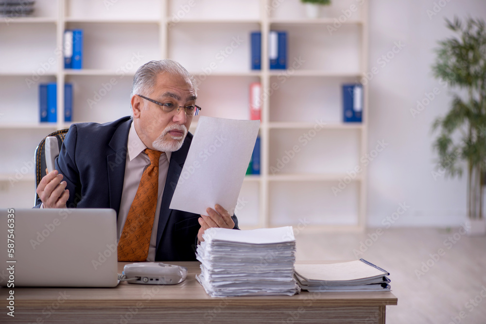 Old male employee and too much work in the office Old male employee and too much work in the office