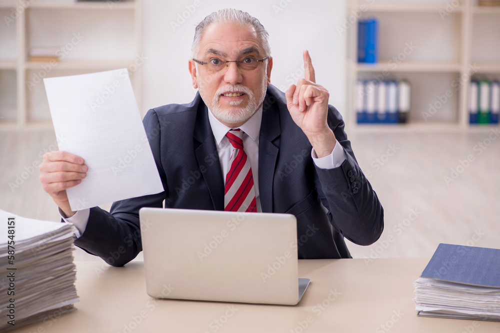 Old male employee and too much work at workplace Old male employee and too much work at workplace