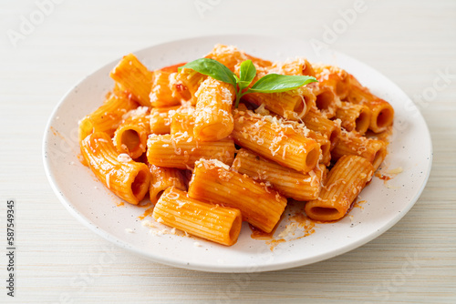 Rigatoni pasta with tomato sauce and cheese photo