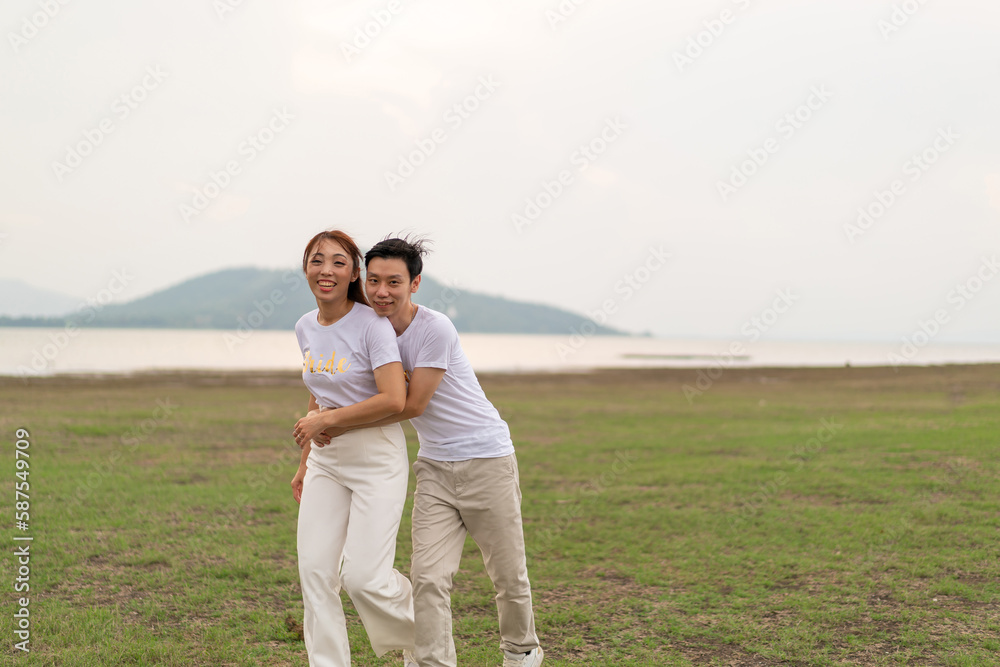 Happy young Asian couple in bride and groom t-shirt Happy young Asian couple in bride and groom t-shirt