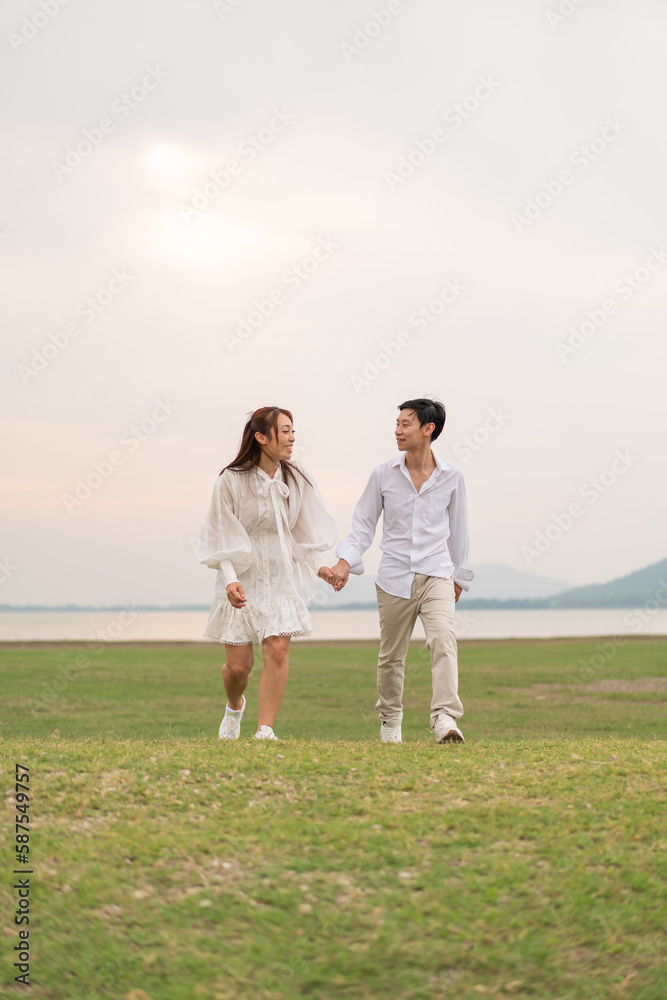 Happy young Asian couple in bride and groom clothing Happy young Asian couple in bride and groom clothing