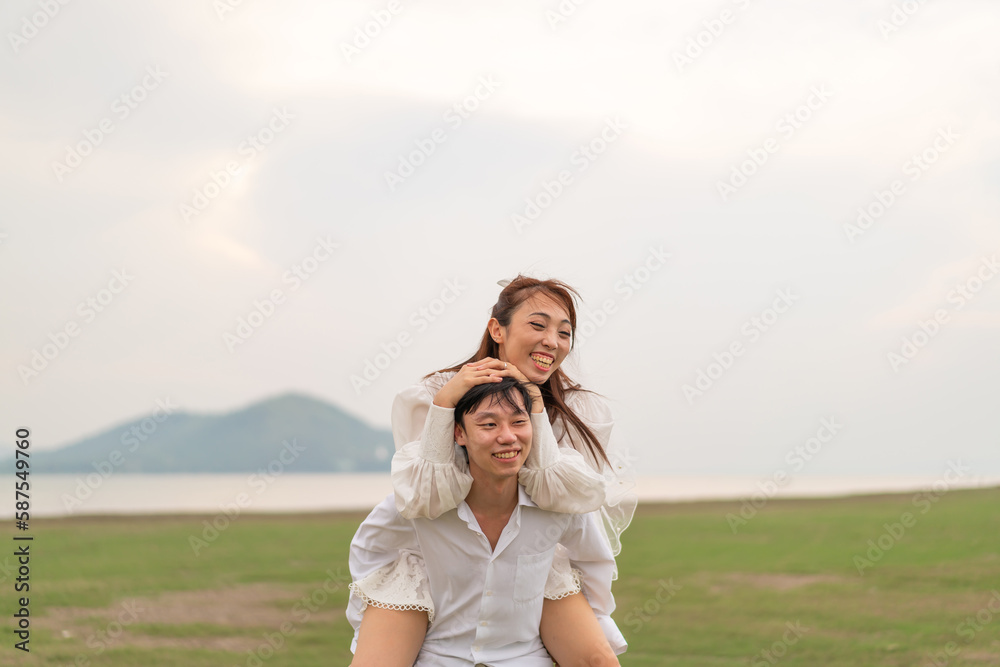 Happy young Asian couple in bride and groom clothing