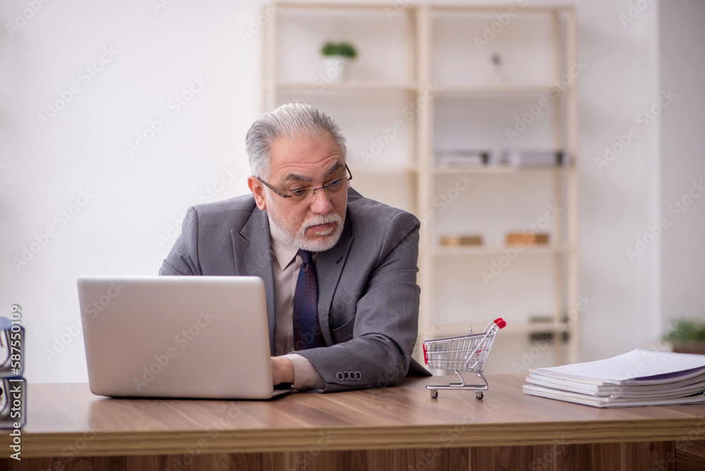 Old male employee in e-commerce concept Old male employee in e-commerce concept