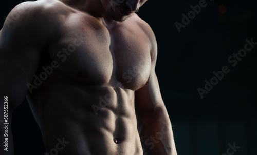 Obraz na plátně Unrecognizable muscular strong man with six pack abs posing on camera at gym