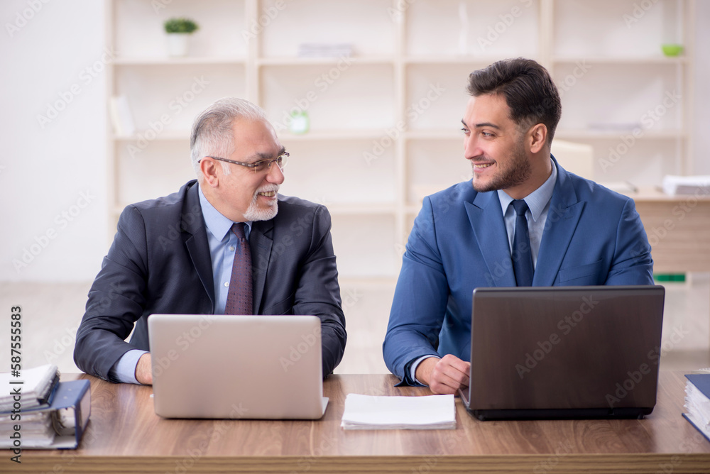 Two male employees working in the office Two male employees working in the office