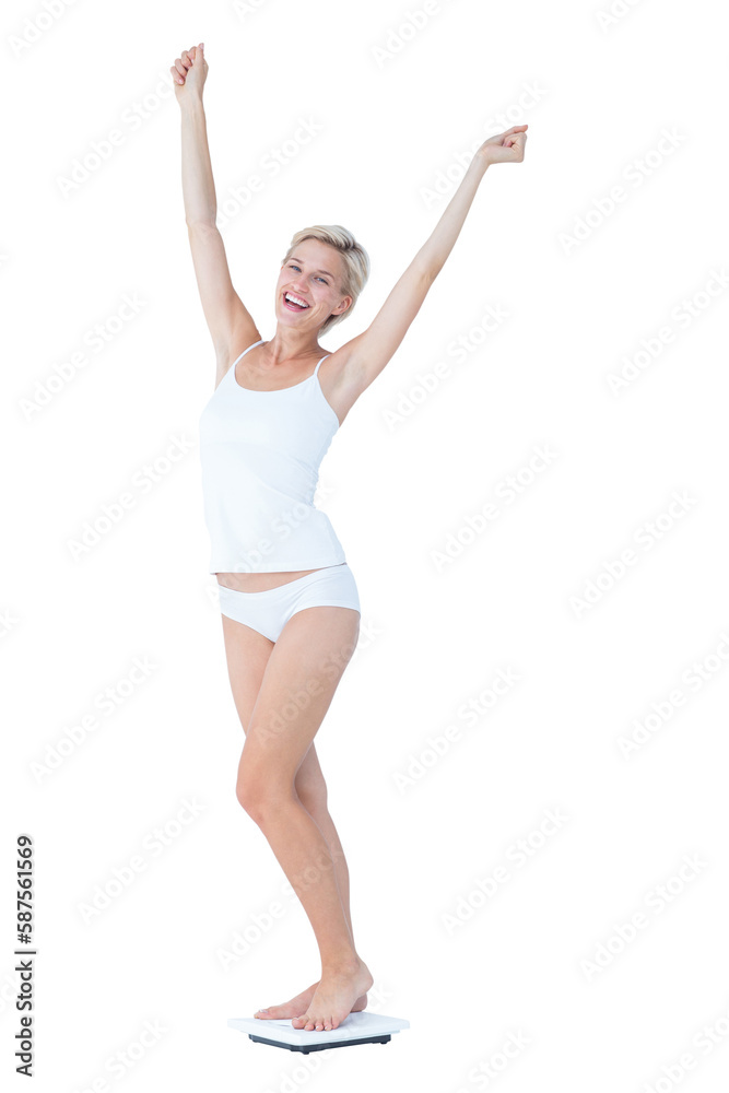 Happy woman standing on a scales spreading her arms Happy woman standing on a scales spreading her arms