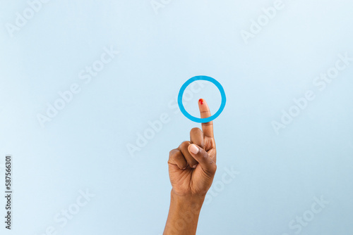Hand of biracial man with blue ring over bleeding finger, on blue background with copy space
