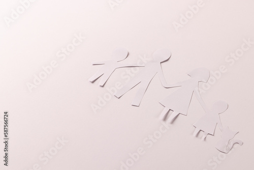 Fototapeta Naklejka Na Ścianę i Meble -  White paper cut out of family with two children and cat and copy space on white background