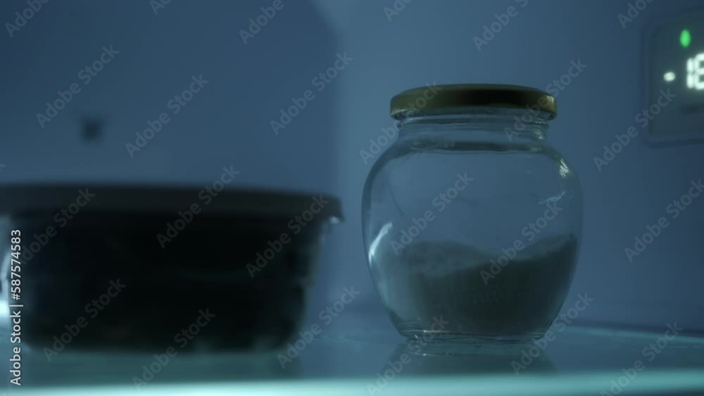 Sweet Refreshment: Close-Up Shot of a Hand Placing a Sugar Bowl in the Fridge Sweet Refreshment: Close-Up Shot of a Hand Placing a Sugar Bowl in the Fridge
