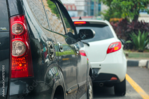 Close up photo of a back lamp of car that stuck in a traffic jam on the highway 