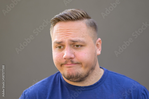 Young man with a thoughtful sad look down © michaelheim