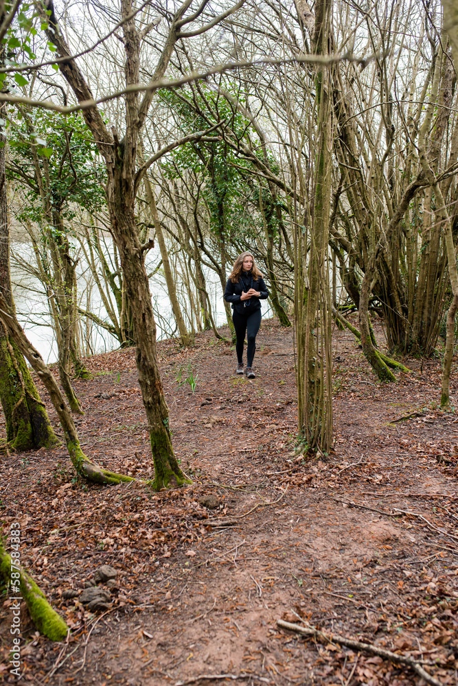 Young woman in sportswear hiking in the Basque Country Young woman in sportswear hiking in the Basque Country