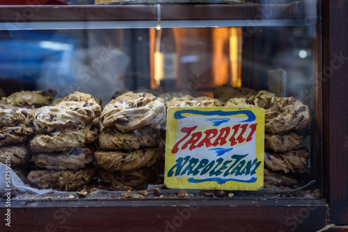 Naples, Italy. Inside a small stall with a showcase, at Via Pignasecca, the typical Neapolitan taralli with lard, pepper and almonds. A traditional tag indicates the name. 2022-08-20. photo