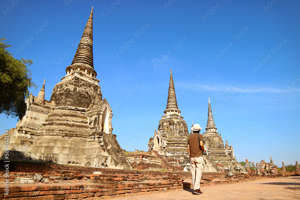 Visitor Walking along the Iconic Historic Pagoda Ruins of Wat Phra Si Sanphet, the Famous Landmark of Ayutthaya, Thailand