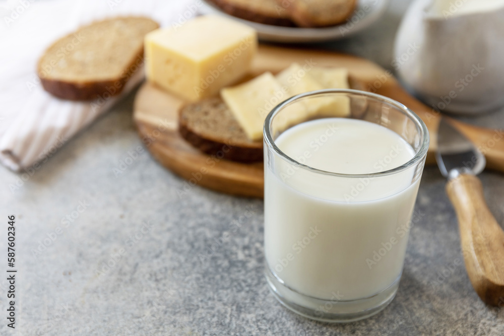 Healthy food concept, breakfast, superfood. Glass of almond milk and fresh whole grain bread with cheese on stone table. Copy space. Healthy food concept, breakfast, superfood. Glass of almond milk and fresh whole grain bread with cheese on stone table. Copy space.