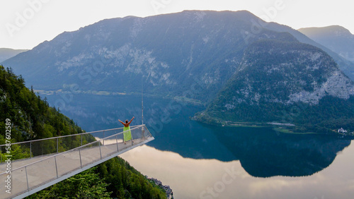 Wallpaper Mural Woman in dress standing on the viewing platform and view of Alps and Hallstatt lake Torontodigital.ca