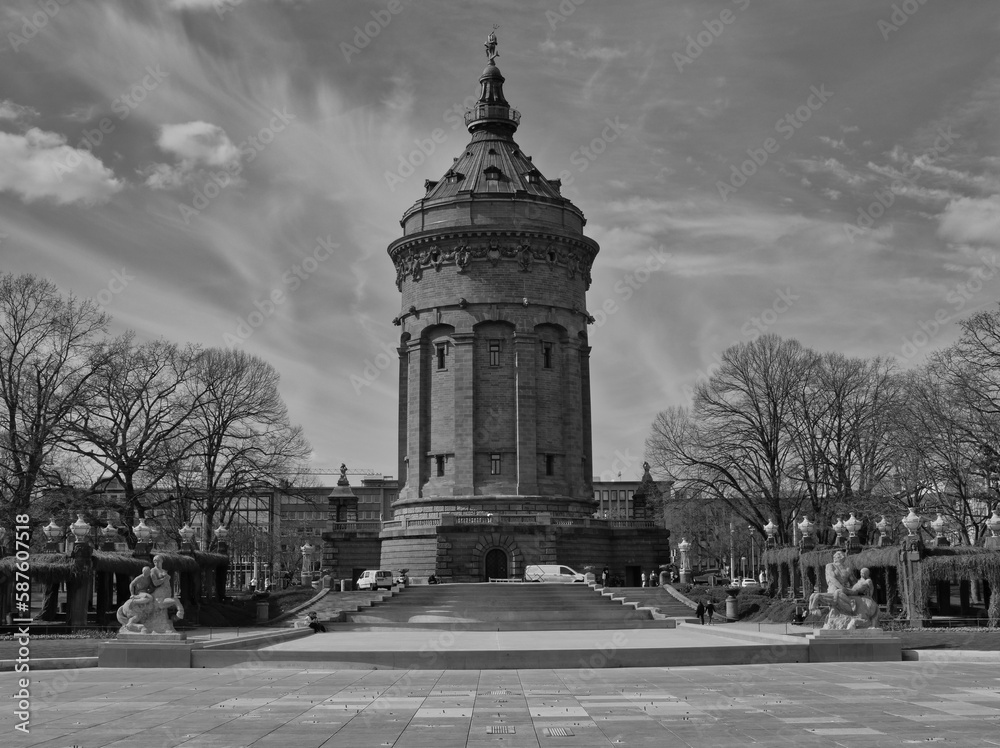 Landmark of Mannheim, the water tower, photographed in black and white, background with many contrails in the sky
