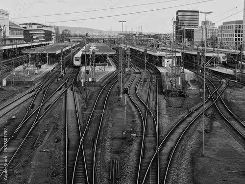 Main station of Mannheim, black and white photo, many rails and a train with freight wagons