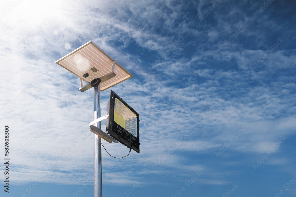 Small solar cell panel with parking LED light, that is an electric eco energy, and sun beam sky background Small solar cell panel with parking LED light, that is an electric eco energy, and sun beam sky background