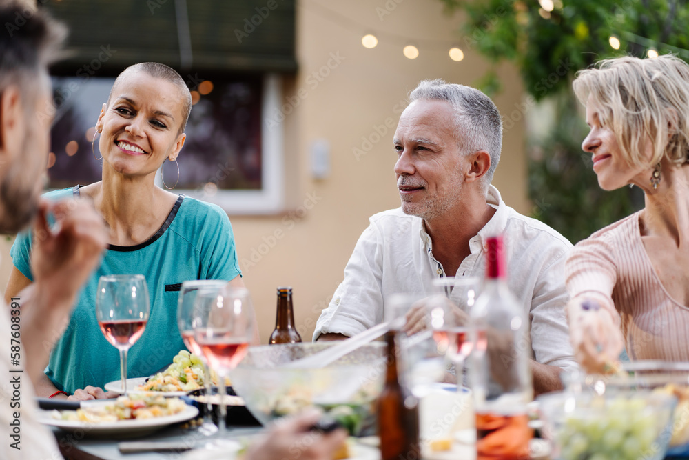 Conversation around the table - Family friends dinner in summer Conversation around the table - Family friends dinner in summer