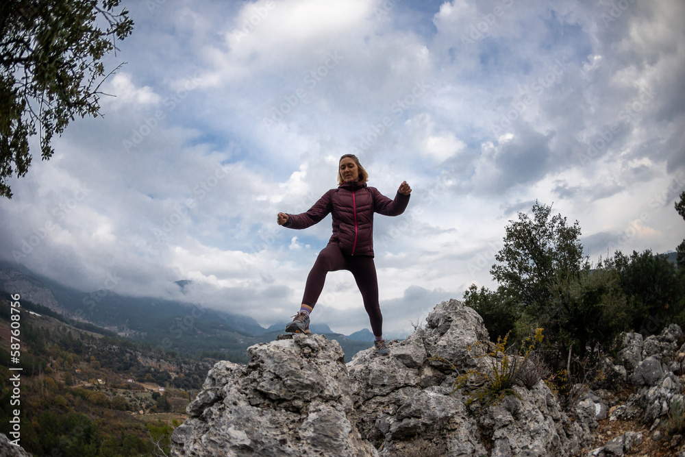 Successful female hiker hiking on a mountain peak. Successful female hiker hiking on a mountain peak.
