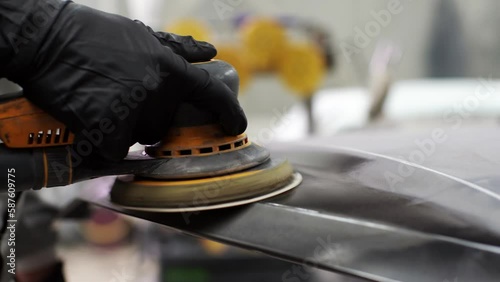 close up, Auto mechanic grinds car part for painting. Car body work auto repair paint after accident