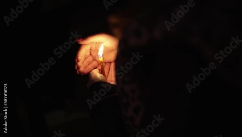 Woman holding lighted candle in her hands at night, Orthodox Easter rithual at midnight - symbol of the Christian faith photo