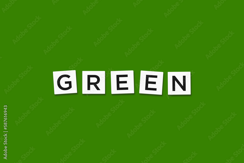The word GREEN, spelt with letter Scrabble tiles on a green background The word GREEN, spelt with letter Scrabble tiles on a green background
